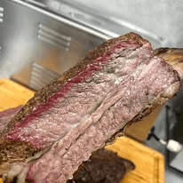 Sliced smoked brisket on a wooden cutting board
