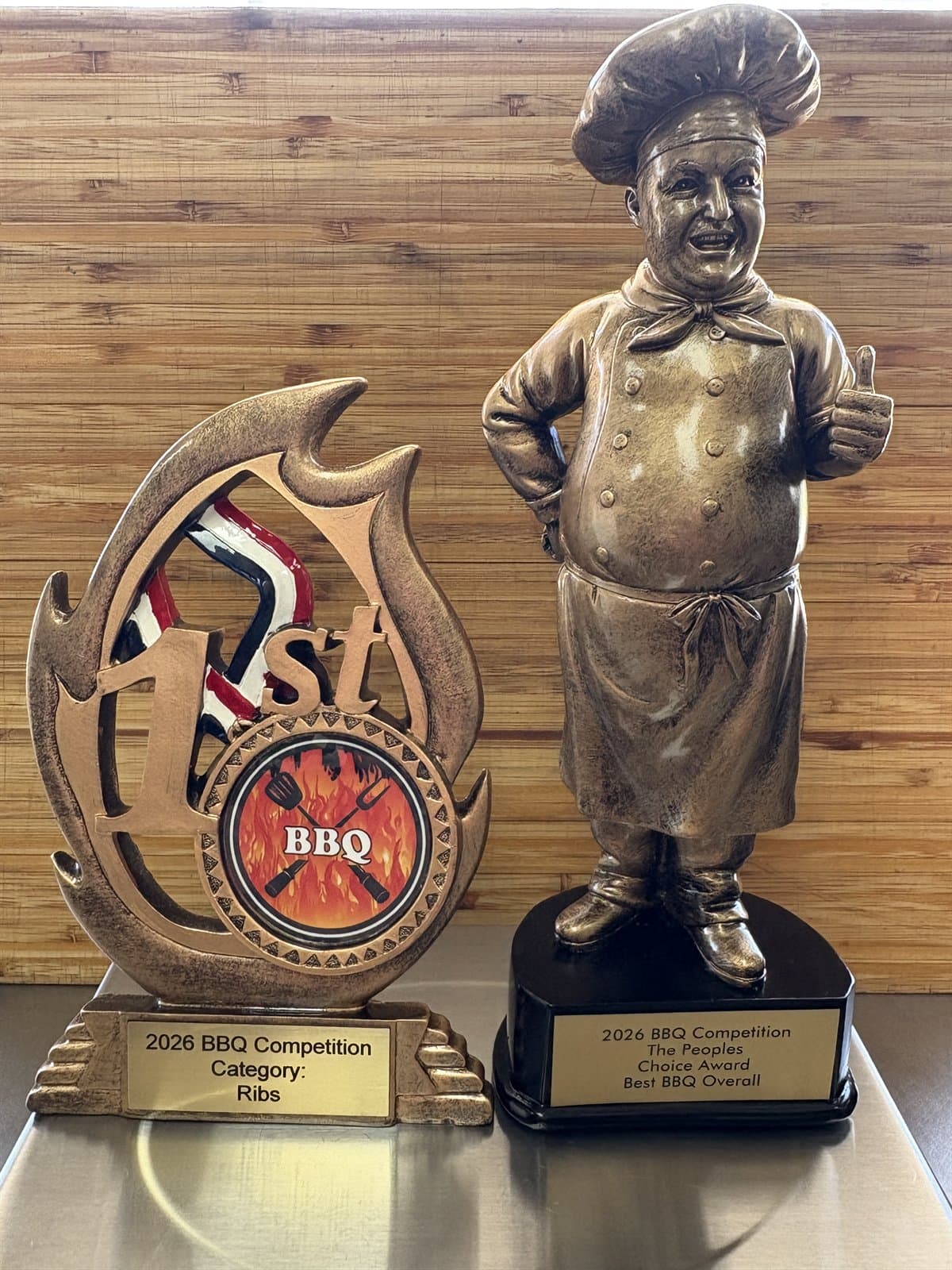 BBQ Art Co.'s 2026 competition trophies — the People's Choice Award for Best BBQ Overall and 1st Place Ribs